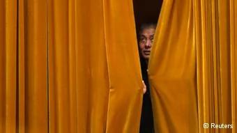 A congress staff draws the curtains during the fourth plenary meeting of the National People's Congress(NPC) at the Great Hall of the People in Beijing, March14,2013. China's parliament formally elected heir-in-waiting Xi Jinping as the country's new president on Thursday, succeeding Hu Jintao, putting the final seal of approval on a generational transition of power. REUTERS/Jason Lee(CHINA- Tags: POLITICS TPX IMAGES OF THE DAY)